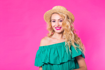 People, positive emotions, facial expressions and lifestyle concept. Young woman with curly hair against pink background, smiles happily