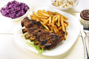 baked ribs and French fries and cabbage salad