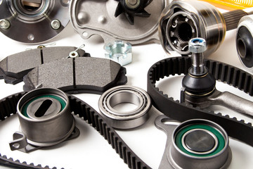 Auto parts background. Hub, pump, brake pads, filter, timing belt, rollers, constant velocity joints, thermostat and other on white background