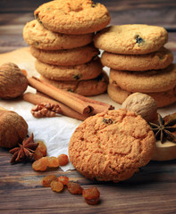 Homemade pastries with spices, nuts and raisins on a wooden table. Close-up. Christmas. A fragrant gift of handmade. Traditions.