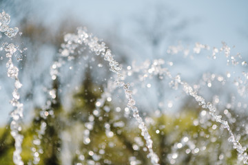 Flow of water fountain. Water splash in a fountain, abstract image.