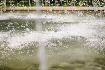 Flow of water fountain. Water splash in a fountain, abstract image.