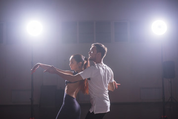 Young couple dancing latin dance Bachata, merengue, salsa. Two elegance pose in dance class