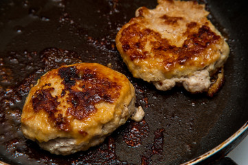 Cutlets fried in a frying pan, fried cutlets to a table