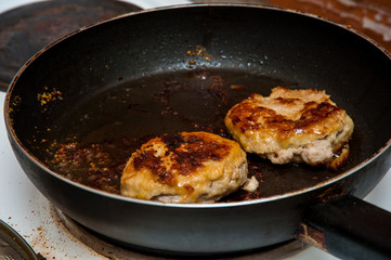 Cutlets fried in a frying pan, fried cutlets to a table