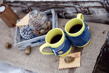 Two cups of coffee, decorated in a rustic desk style