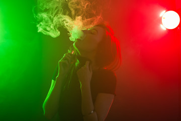 young woman smoking electronic cigarette