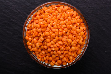 raw lentils on a dark stone background