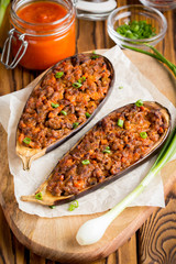Stuffed eggplant, aubergine, ground beef, pork, vegetables, tomato sauce, rustic style