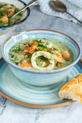 Creamy seafood stew garnished with fresh dill