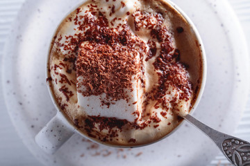Hot chocolate and marshmallow sprinkled with chocolate chips.