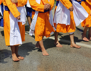 Sikh barefoot soldiers wear an orange dress