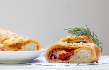 cut a piece of baked wrapped hot pizza in a dough