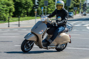 Man riding a classic scooter