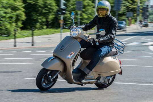 Fototapeta Man riding a classic scooter
