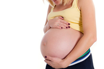 pregnant woman hugging her naked belly her hands