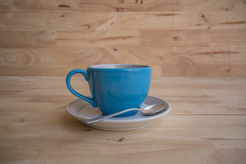Blue coffee cup  on the wood texture background