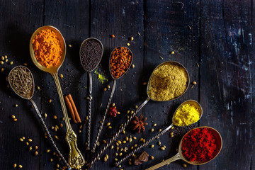Indian spices selection over dark wooden table. Food or spicy cooking concept, Healthy eating Background.