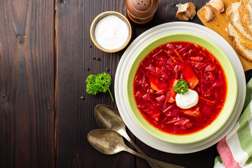 Borsch - traditional Ukrainian and Russian beetroot soup on dark wooden background