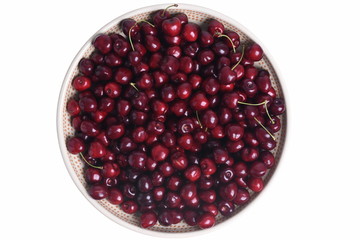 Fresh sweet cherry in round bowl isolated on white background top view
