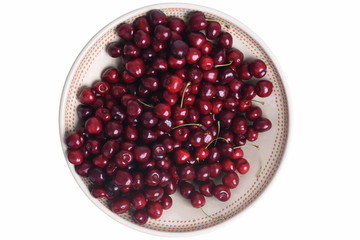 Fresh sweet cherry in round bowl isolated on white background top view