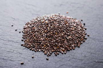 chia seeds on a dark stone background
