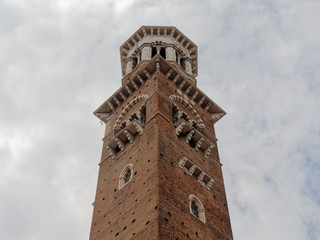 Fototapeta premium View up to the top of renaissance tower on cloudy sky