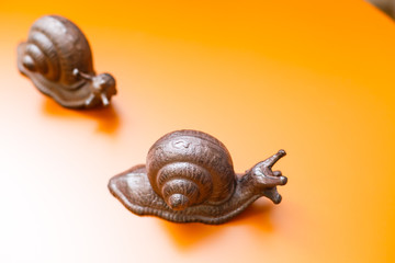 Dating snails. Funny concept, isolated on yellow background.