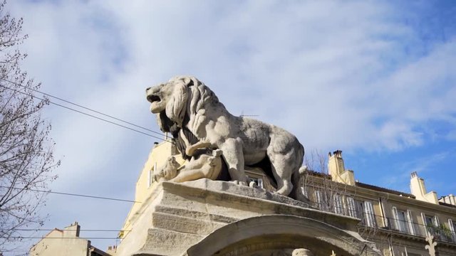 Stone lion sculpture, oldest street in the capital of Spain, the city of Madrid. Stock. Lion statue in the middle of a European city