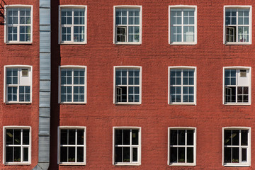 Fototapeta na wymiar Building with windows made of red brick