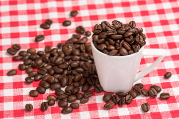 White coffee mug with brown coffee beans