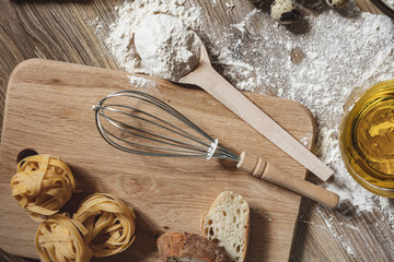 Sliced homemade wheat bread with wheat flour on a wooden background. Ton view