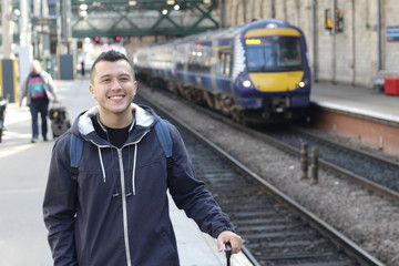 Fototapeta na wymiar Smiley ethnic male waiting for a train