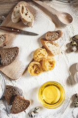 Sliced homemade wheat bread with wheat flour on a wooden background. Ton view