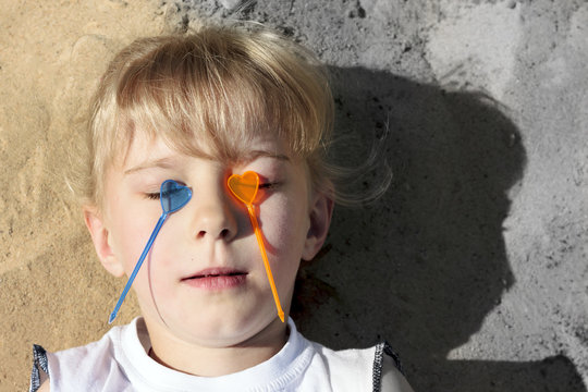 Little girl with hearts on eyes. The photo is divided into two halves with or without an inscription. No weapons - Powered by Adobe