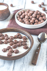 Bowl of chocolate corn balls with milk