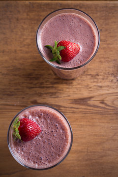 Two Glasses Of Chocolate Strawberry Milkshake Or Cocktail On Wooden Table.  Strawberry Chocolate Smoothie With Berries. Healthy Drinks. Overhead, Vertical