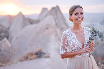 Beauty and nature. Fairy and sensual portrait of pretty young woman against mountains view.