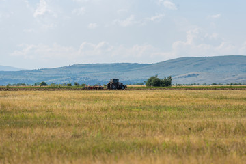 Fototapeta na wymiar Tractor plowing fields.