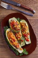 Zucchini stuffed with meat, vegetables and cheese. Zucchini boats. View from above, top studio shot