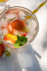 Cold fresh lemonade drink with strawberry and lemon close up. Selective focus.Top view.