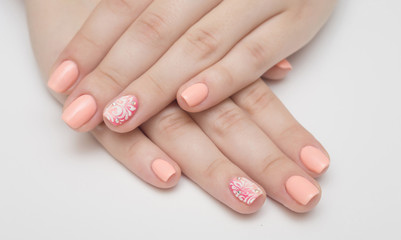 beautiful female hands with pink nail polish on a white background, spa treatments