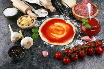 Fresh original Italian raw pizza preparation with fresh ingredients