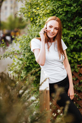 Girl in the park iwith smartphone