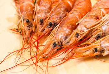 group of fresh red langoustine focus on the head seafood with long mustache on a light background