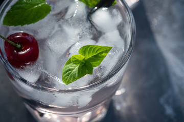 Cold lemonade with mint, cherry and ice. Chilled drink. Top view. 