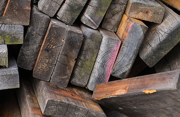 pile of old boards weathering dark covered moss wreckage building materials background wooden grunge
