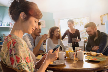 Group of multi-ethnic friends gathered around a table for breakfast