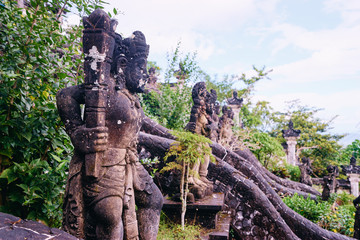 Naklejka na ściany i meble Traditional Balinese stone sculpture art and culture at Bali, Indonesia.