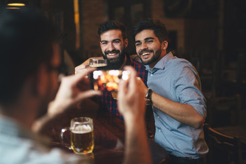 The guys in the pub are drinking beer